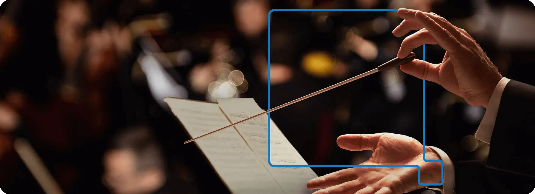 A conductor holding a conductor's baton
